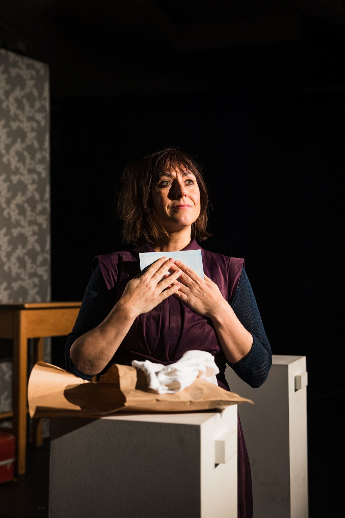 Sarita Plowman as Kathleen, holding a letter to her chest